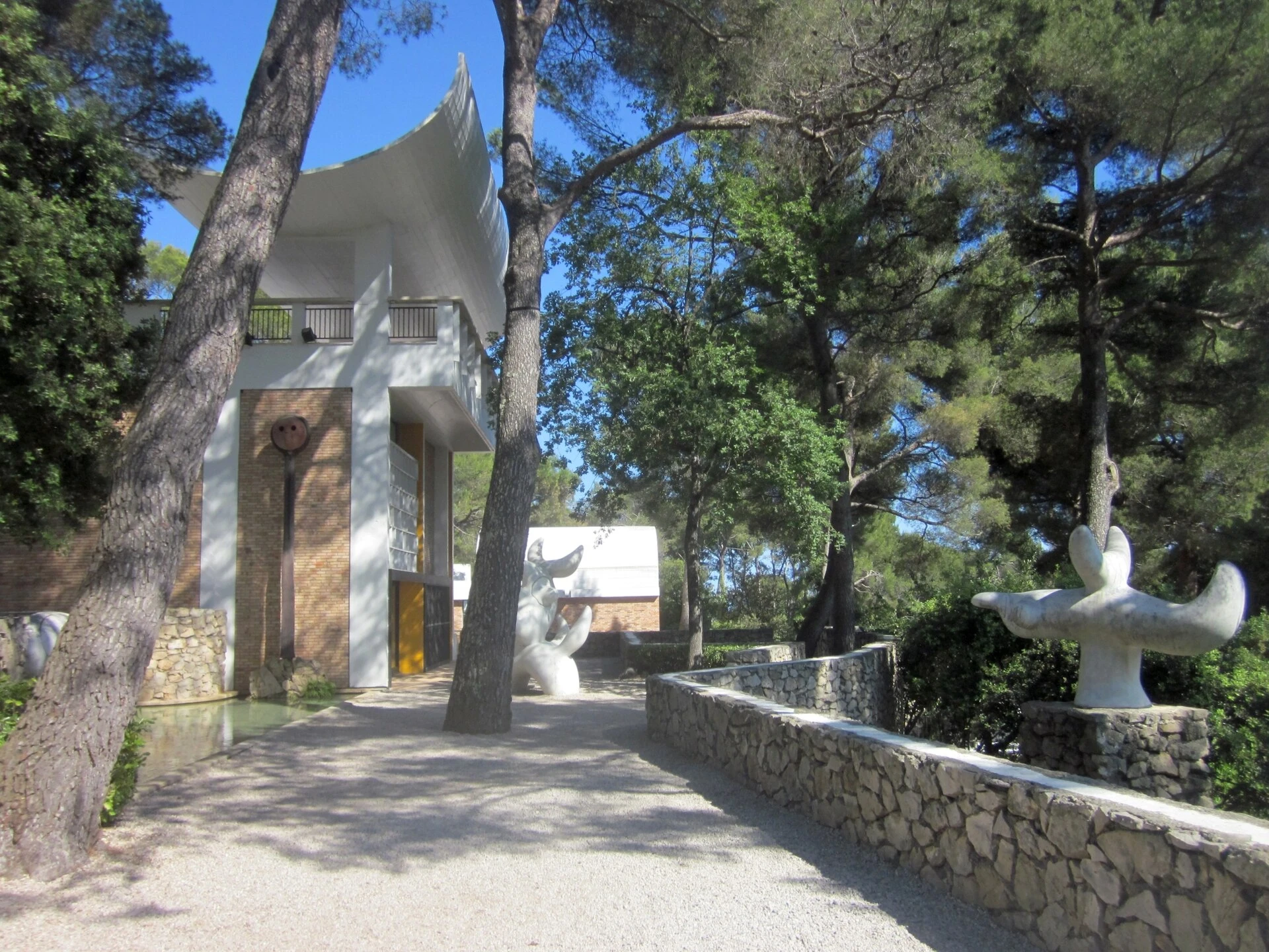 The Miró Labyrinth at the Fondation Maeght, with its stone walls and sculptures beneath one of Sert's white roof vaults