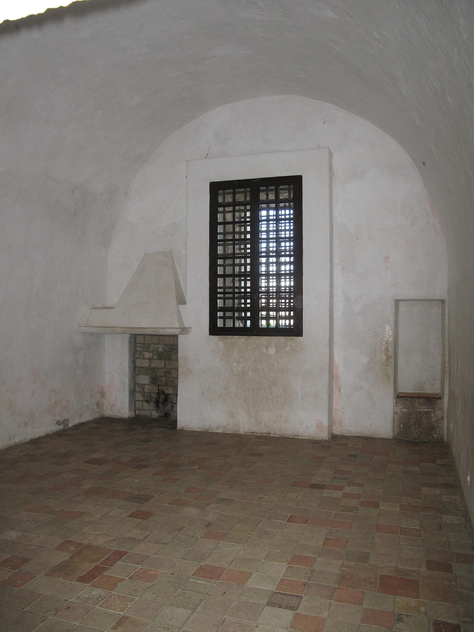 The Man in the Iron Mask's cell in the Royal Fort, with its fireplace and barred window